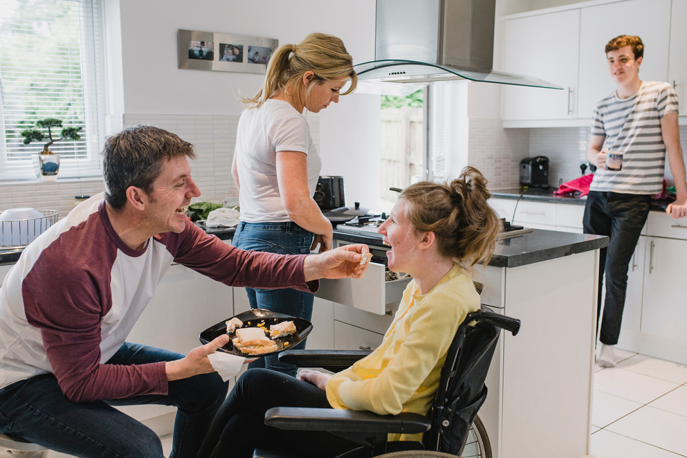 Family with Disabled Daughter in Kitchen at Home